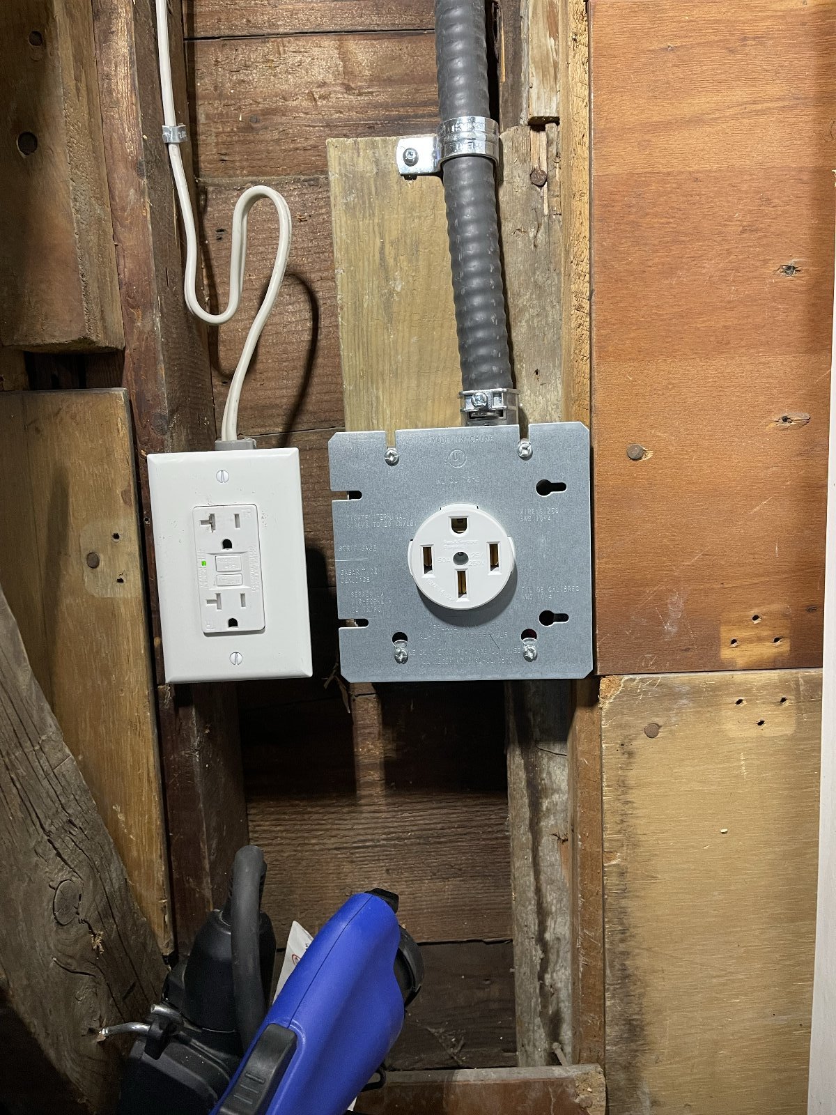 NEMA 14-50R in a 4-square box, FMC clamped clean. GFCI receptacle below for the convenience circuit.