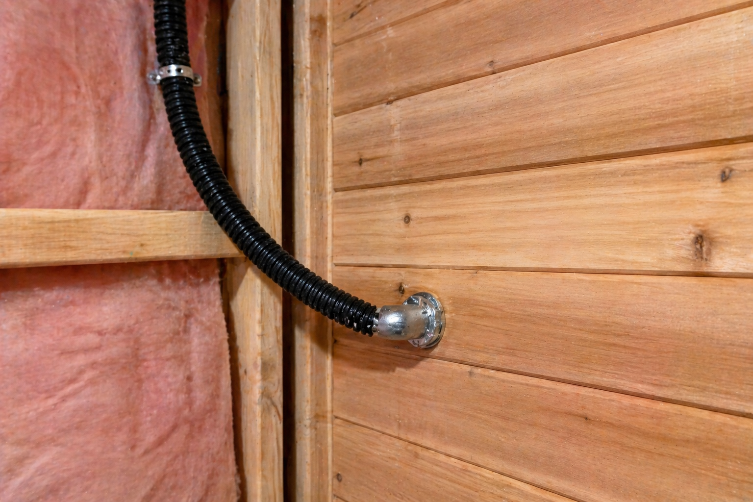 High-temp flex coming through the cedar at the heater location — chrome bushing, properly strapped on the cold side, sized for the heater’s nameplate.